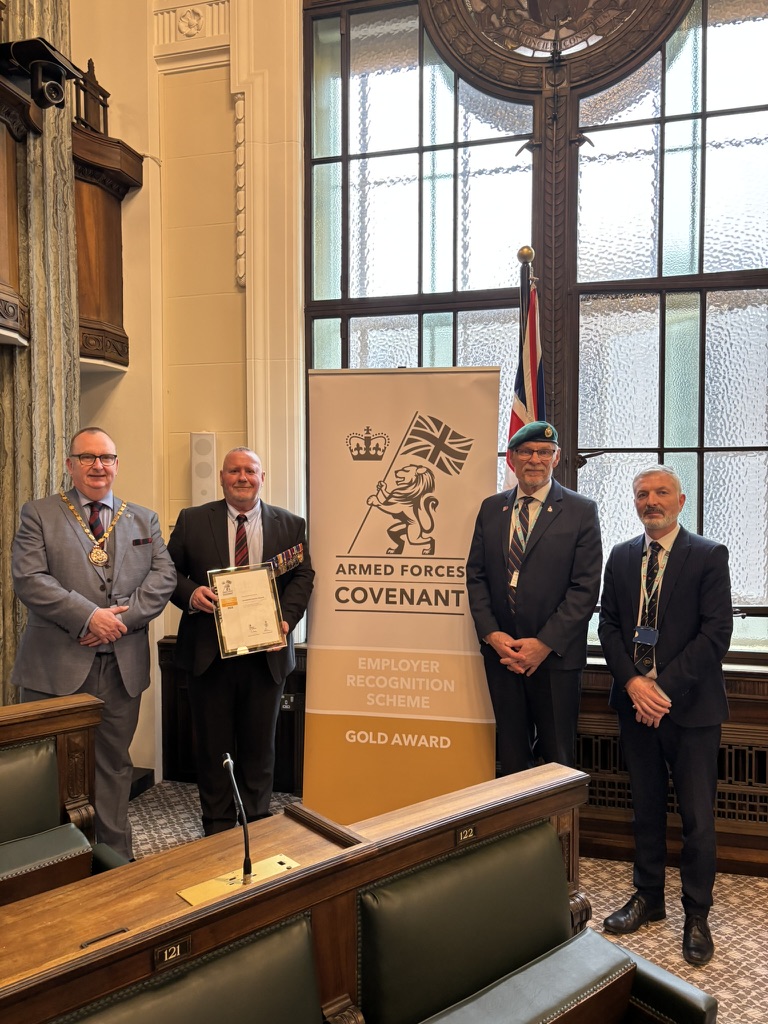 Chairman Alf Clempson, Armed Forces Champion Gary Kniveton, Senior Officer Kieran Curran, and armed forces covenant representative with the Gold Award certificate at County Hall